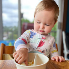 Load image into Gallery viewer, Baby girl reaches into a sectioned bowl for banana at snack time.
