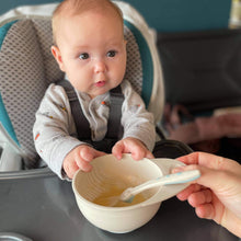 Load image into Gallery viewer, A mom gives baby homemade puree in littoes food masher bowl. A baby feeding spoon is in the bowl.
