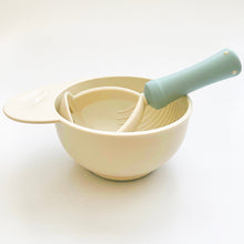 Load image into Gallery viewer, Blue neutral style food masher is in a mashing bowl with nonslip base. 
